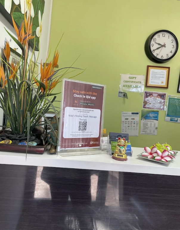 Welcoming reception area at Nida's Healing Touch with tropical plants