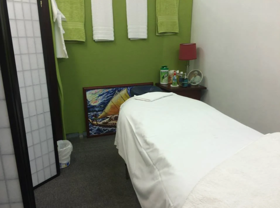Private massage suite with calming green walls